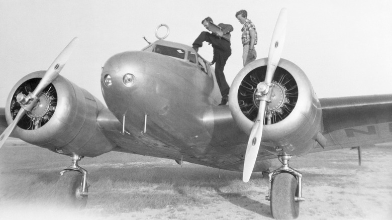 Amelia Earhart and her navigator Fred Noonan with their Lockheed Electra 10E